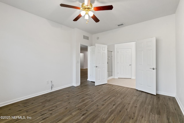 unfurnished bedroom featuring ceiling fan and dark wood-type flooring