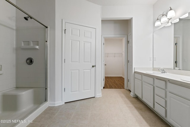 bathroom featuring tile patterned floors, vanity, and walk in shower