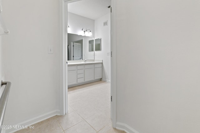 hallway with sink and light tile patterned floors