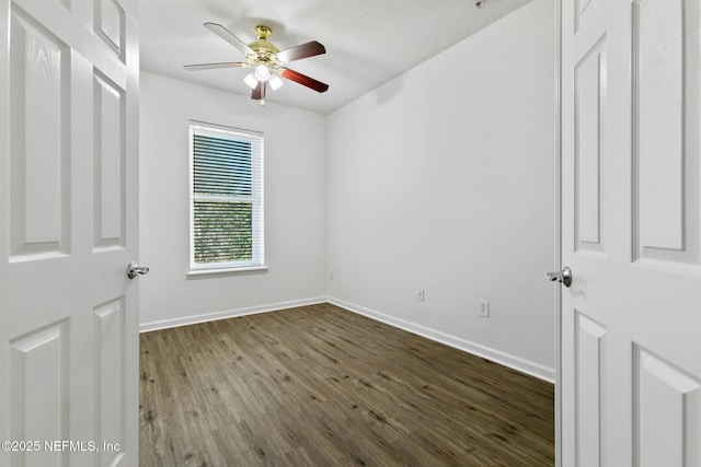 spare room with ceiling fan and wood-type flooring