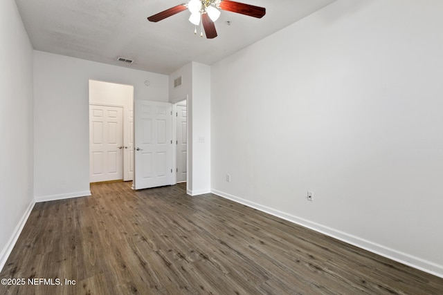 unfurnished bedroom featuring ceiling fan and dark hardwood / wood-style floors