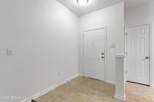 tiled entrance foyer featuring a textured ceiling