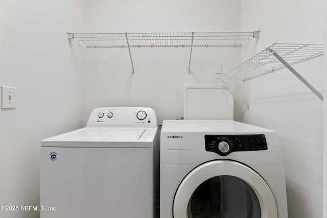 washroom with washing machine and dryer