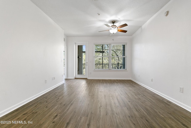 unfurnished room with ceiling fan and dark hardwood / wood-style flooring