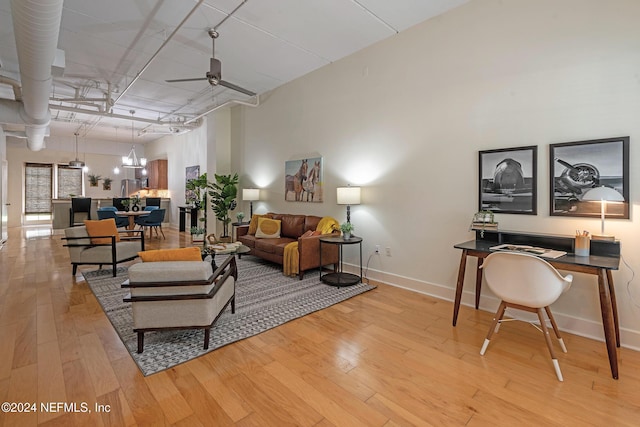 living room featuring ceiling fan and light hardwood / wood-style floors