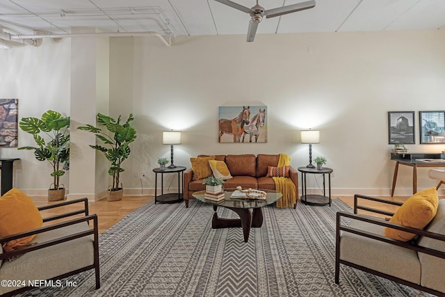 living room featuring ceiling fan and light wood-type flooring