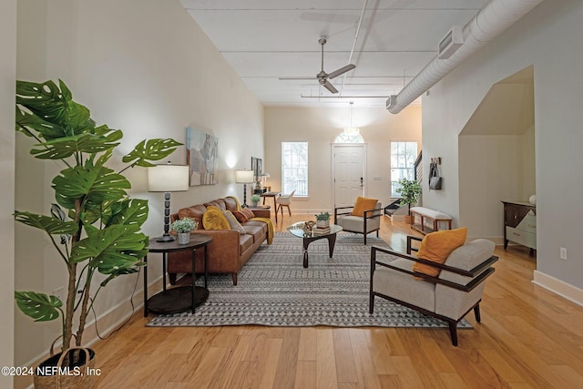 living room featuring ceiling fan and light wood-type flooring