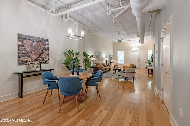 dining room with an inviting chandelier and light hardwood / wood-style flooring