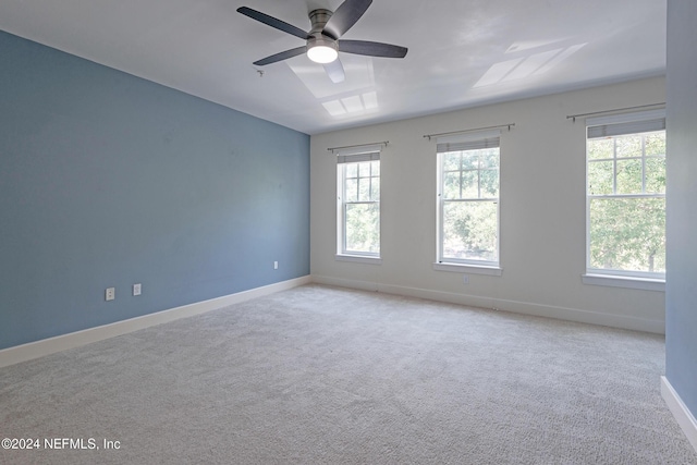 unfurnished room featuring ceiling fan and light colored carpet