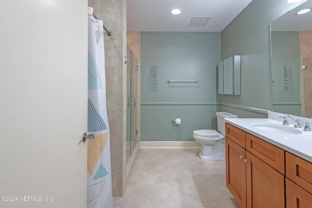 bathroom with tile patterned floors, vanity, toilet, and a shower with shower door