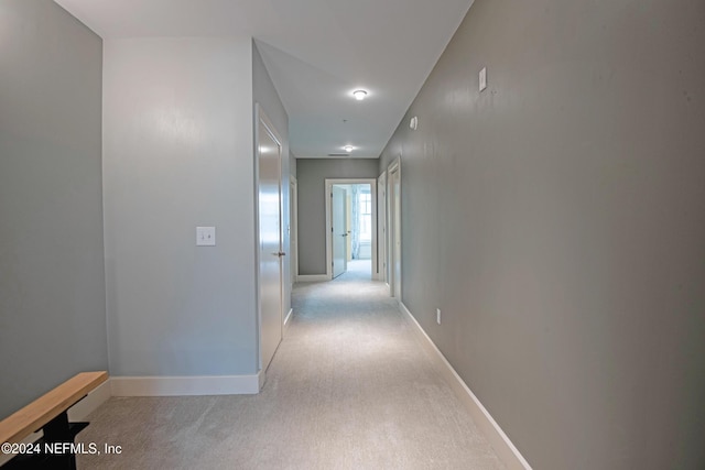 corridor featuring light colored carpet