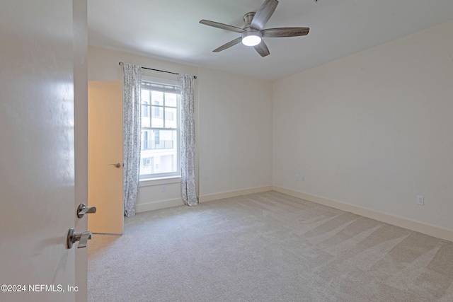 carpeted empty room with ceiling fan