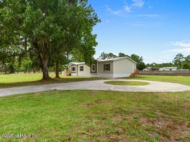 ranch-style home featuring a front yard