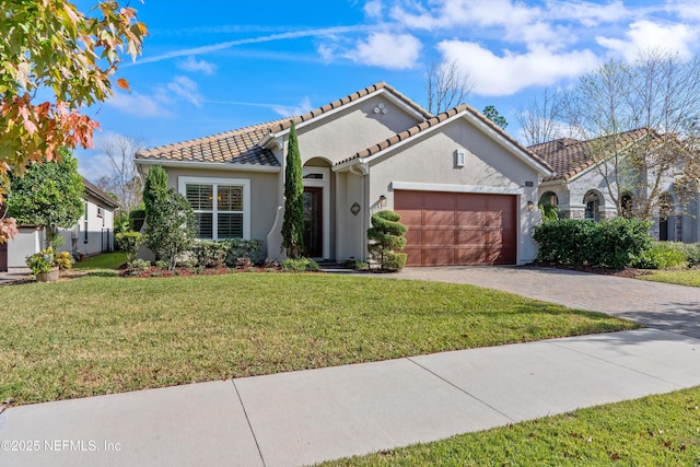 mediterranean / spanish house with a garage and a front yard