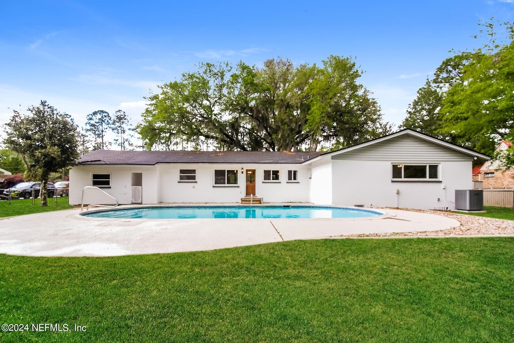 view of pool featuring a patio area, a yard, and cooling unit