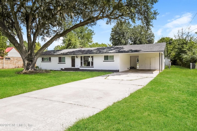 single story home with a front yard and a carport