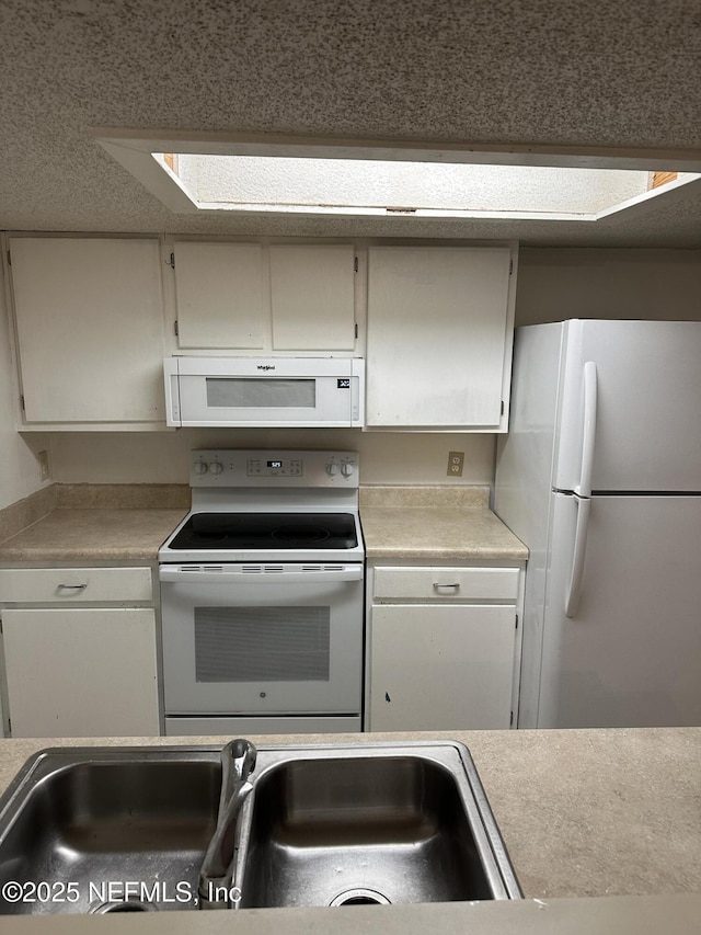 kitchen with white appliances and sink