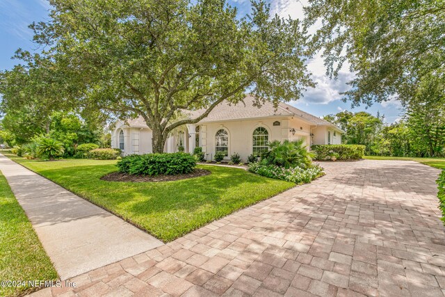 mediterranean / spanish-style house featuring a front yard