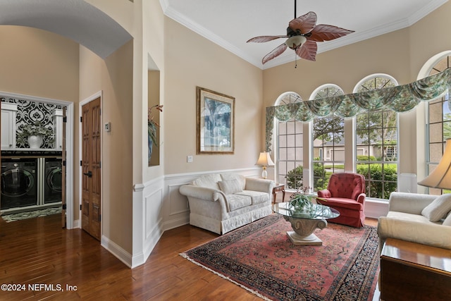 living room featuring ceiling fan, dark wood-type flooring, washer and dryer, and ornamental molding