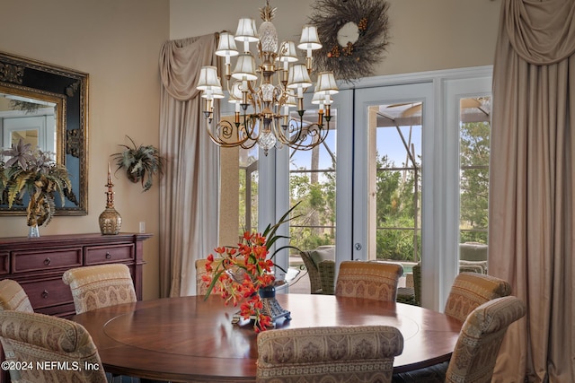 dining area with a notable chandelier and french doors