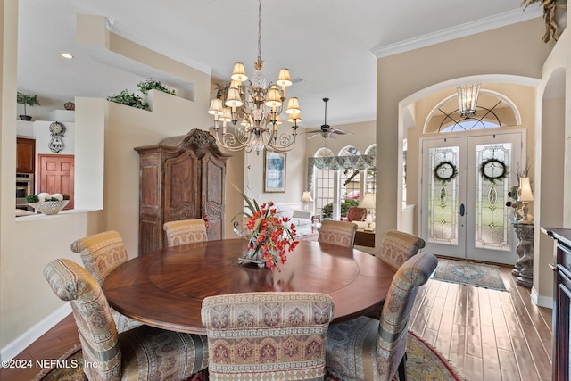 dining area with crown molding, french doors, ceiling fan with notable chandelier, and plenty of natural light