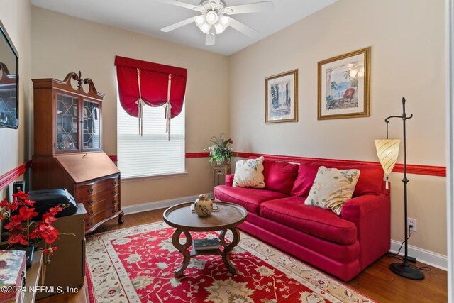 living room featuring wood-type flooring and ceiling fan