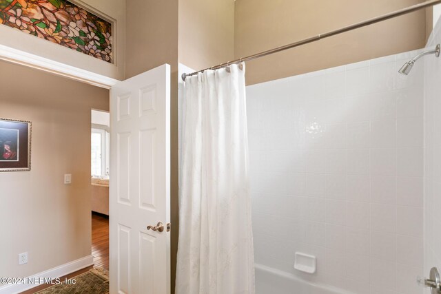 bathroom featuring shower / tub combo and hardwood / wood-style flooring