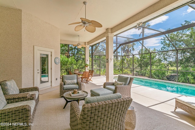 view of patio with glass enclosure, ceiling fan, and outdoor lounge area