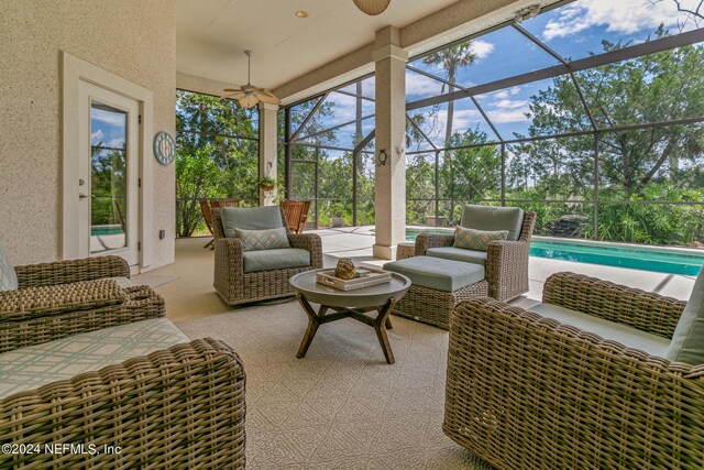 sunroom featuring ceiling fan and a swimming pool