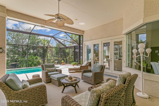 sunroom / solarium with ceiling fan, a healthy amount of sunlight, and a pool