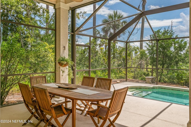 exterior space with plenty of natural light and a pool with hot tub