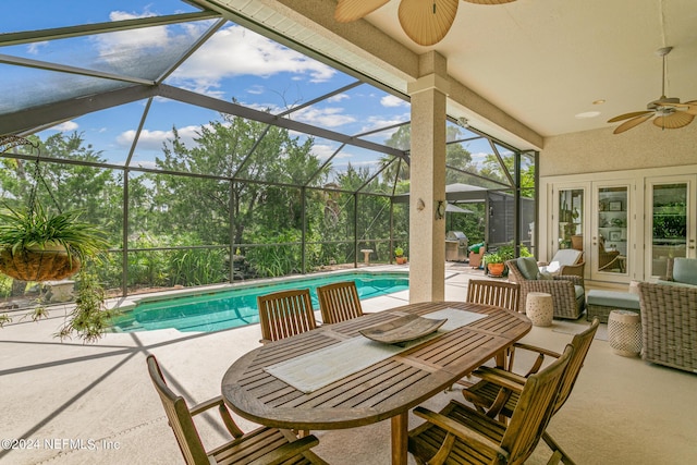 exterior space with ceiling fan, glass enclosure, and french doors