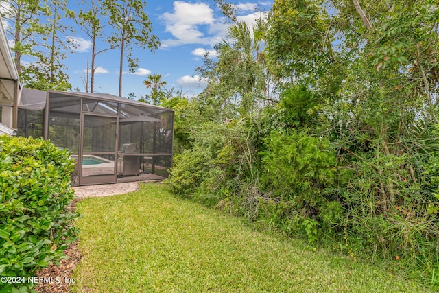 view of yard with a lanai