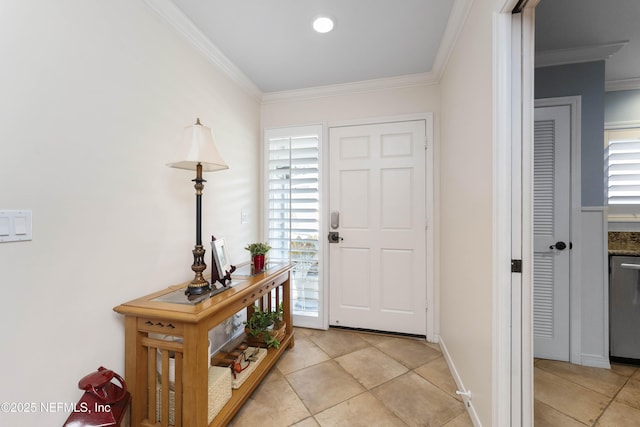 entryway with crown molding and light tile patterned floors