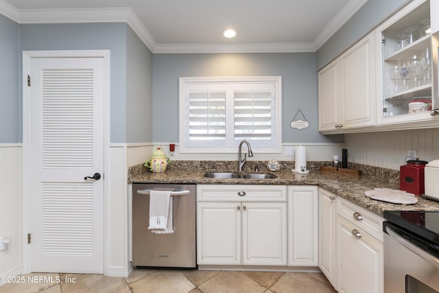 kitchen featuring dishwasher, white cabinets, sink, crown molding, and dark stone countertops