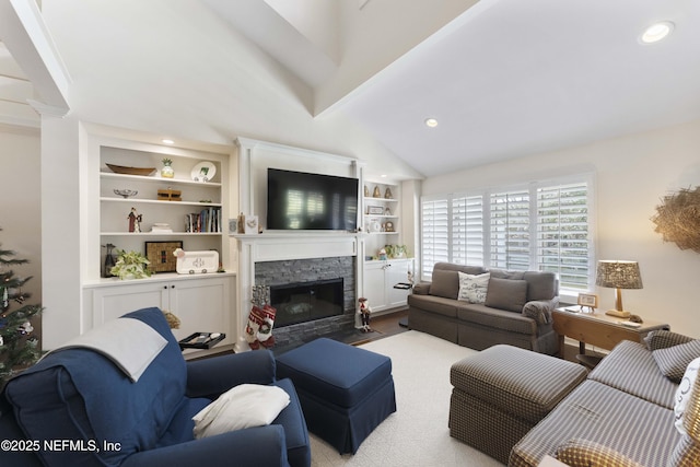 living room featuring vaulted ceiling and a stone fireplace