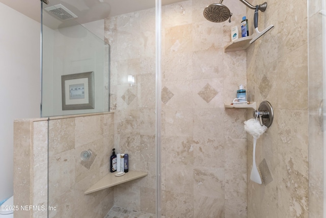 bathroom with a tile shower