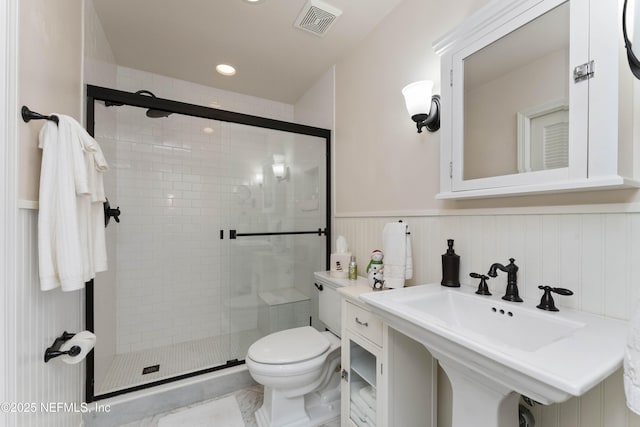 bathroom featuring toilet, walk in shower, and sink