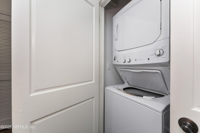 laundry area with stacked washing maching and dryer