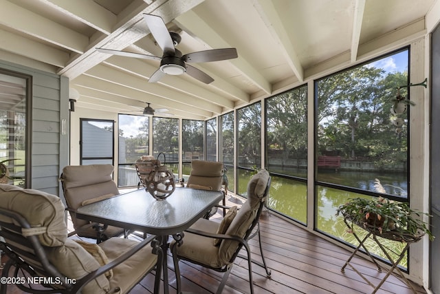 sunroom / solarium with ceiling fan, beam ceiling, a water view, and a wealth of natural light