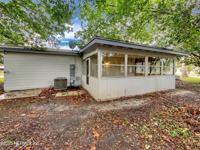 view of side of property featuring a sunroom and central air condition unit