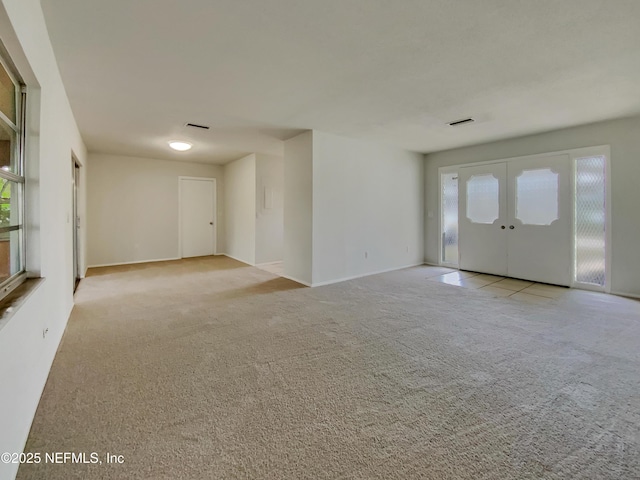 empty room with light carpet and french doors