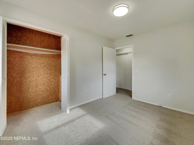 unfurnished bedroom featuring carpet flooring and a closet