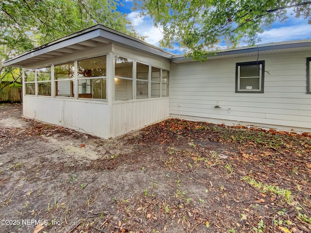 view of property exterior featuring a sunroom