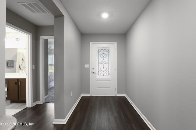 entryway with hardwood / wood-style flooring and a textured ceiling