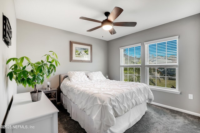 bedroom featuring dark colored carpet and ceiling fan