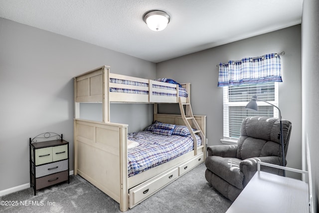 carpeted bedroom featuring a textured ceiling