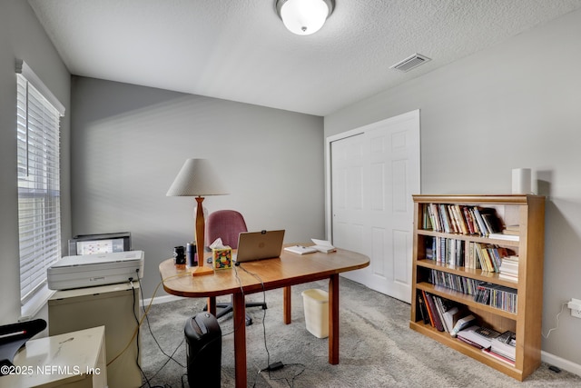 office with carpet and a textured ceiling