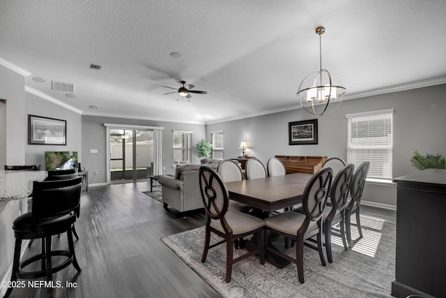 dining room with a textured ceiling, ceiling fan with notable chandelier, and crown molding