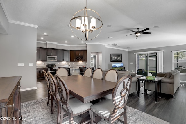 dining room with ceiling fan with notable chandelier, dark hardwood / wood-style floors, and ornamental molding